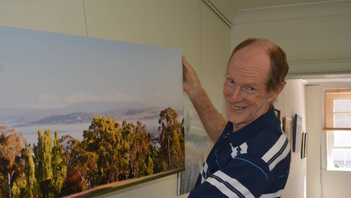 PRIZED: Terry Cooke hangs one of the photos selected for his coffee table book, tipped to be published in November.