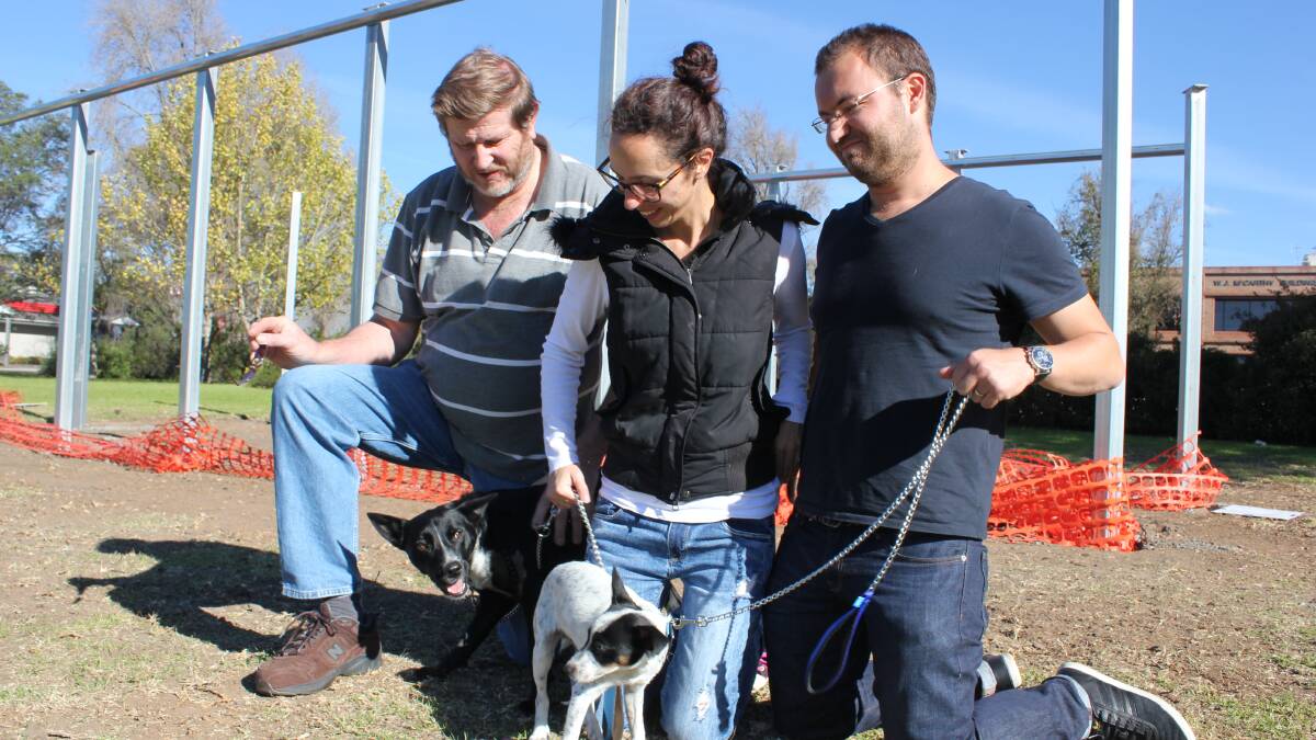 CARING: Andrew Murat with Marcus and Kelly Ehrlich and their two dogs they’ve adopted from Armidale.  Story, Photo: LUCAS FORBES