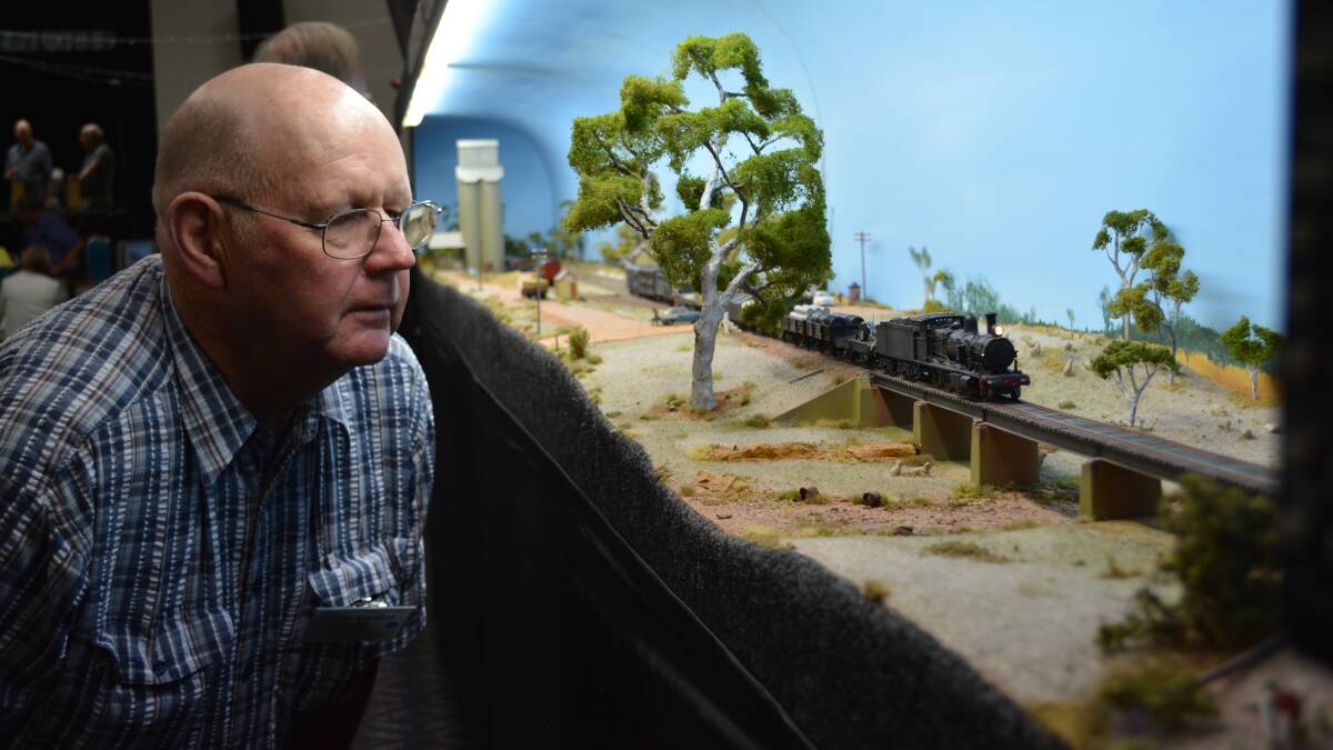 HOBBY: New England Railway Club secretary Geoff Yeomans inspects one of displays showing a train powering through rural NSW at the New England Railway Club Convetnion.