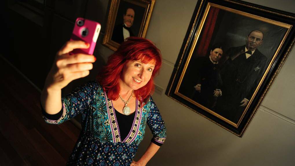 DUBBO: WPCC education officer Lisa Minner, taking a selfie alongside the gallery's traditional portraits. Photo: BELINDA SOOLE