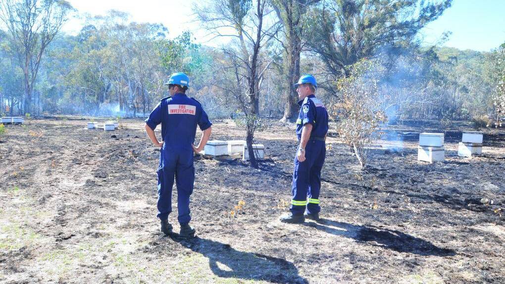 ORANGE: INVESTIGATION: The Rural Fire Service’s Mike Spira and Steve Smith at the site of the Lower Lewis Ponds Road fire this week. Photo: JUDE KEOGH