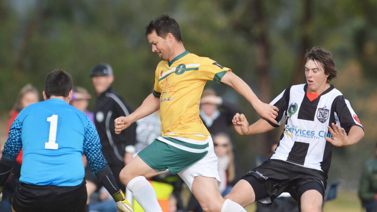 Joeys FC coach Steve Gadd races past Will Howard in search of the ball. 260714BSB28