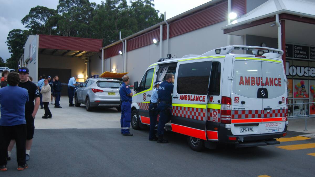 Police interview witnesses, including the robbery victim in the ambulance, at the St Georges Basin IGA.