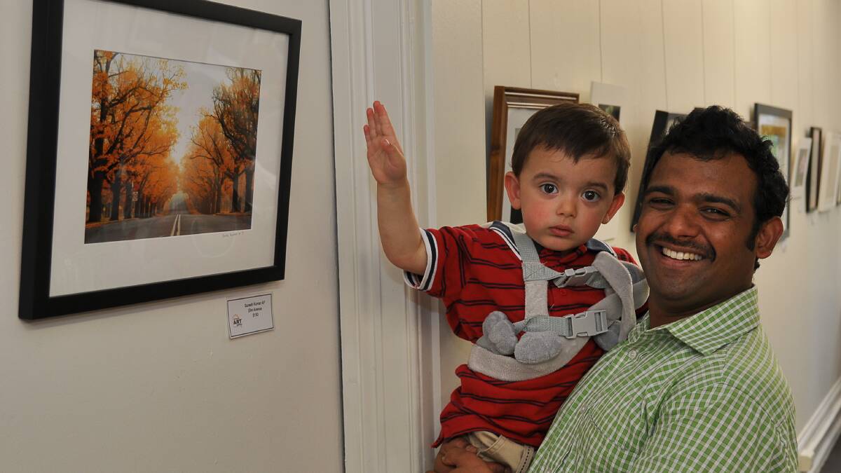 LEAFY LENS: Little Theeran Daniel points out his favourite photograph at the gallery, which just so happens to be the one taken by his father Suresh Kumar.