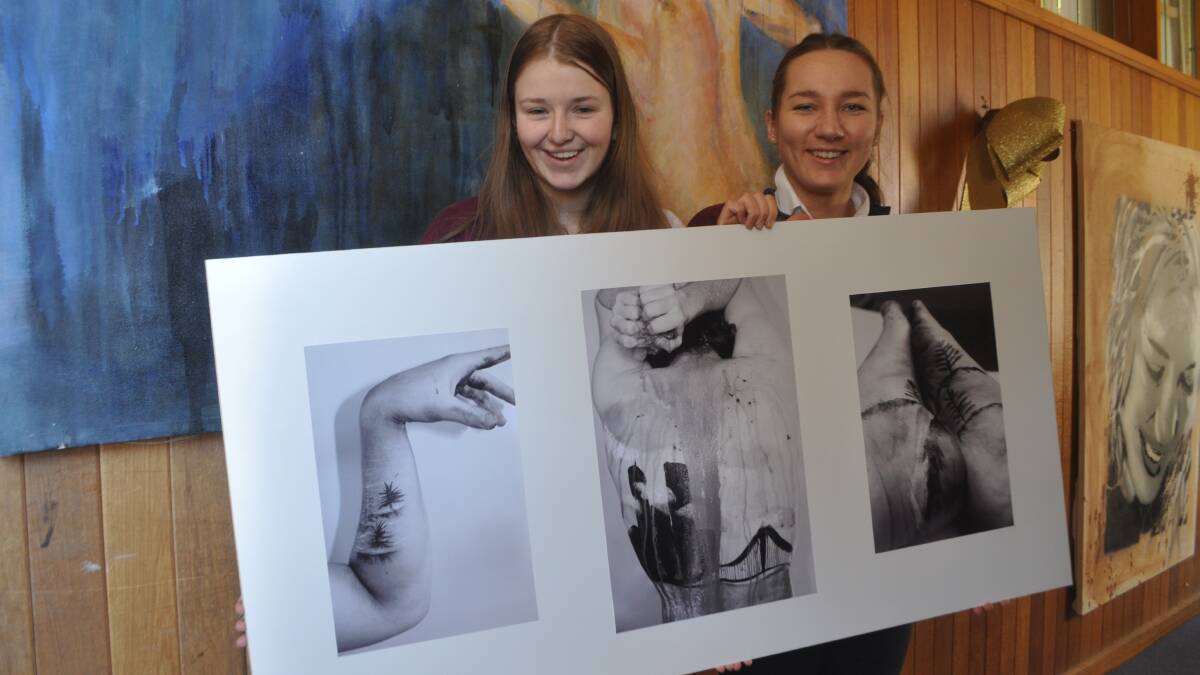 FEAST YOUR EYES: Exhibiting students Rebecca Keogh and Emily Ryan hold up Emily’s major art project, which will be displayed this week.