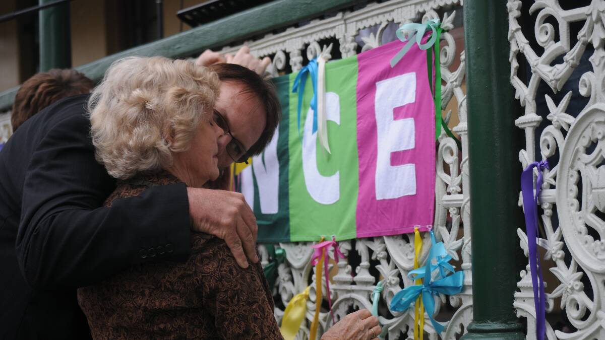 FOR THOSE WHO DIDN’T MAKE IT: Peter Jurd comforts mother Claire as the pair tied a ribbon for Damian Jurd at the Loud Fence launch on Thursday afternoon.
