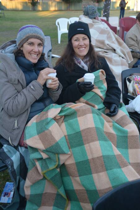 SNUG AS A BUG: Kath Caddy and Jane Dutton kept their insides warm with a cup of coffee ands let their blankets do the rest at the ctiy’s Winter Fest.