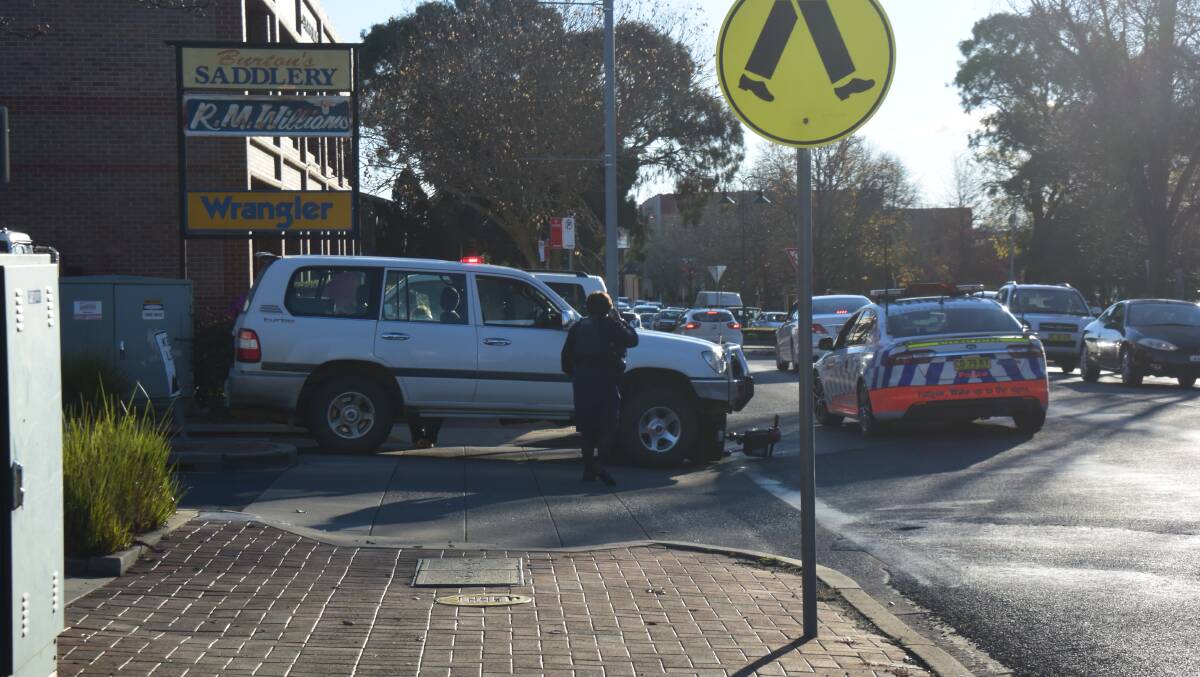 STUCK DOWN: Police at the scene of the accident on Wednesday afternoon. Photo MEG FRANCIS.