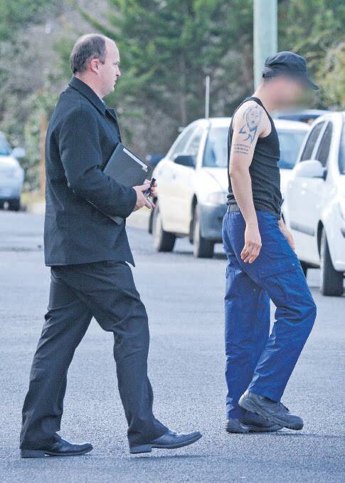 ARRESTED: Dectectives lead a 29-year-old Armidale man away for questioning. Photo, Northern Daily Leader. 