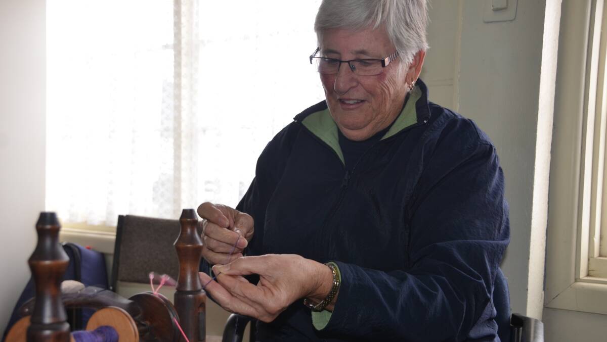 SPINNERS ARE GRINNERS: Sue Davies says a community assistance grant will stitch up better shelves for her club. Photo, story HANNAH PAINE.