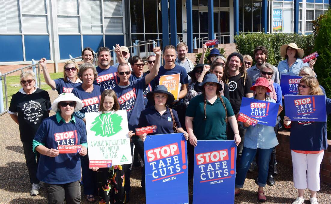 FISTS OF FURY: Greens’ New England candidate Mercurius Goldstein, centre, joins protesters in a snap rally at TAFE’s Armidale campus on Wednesday.