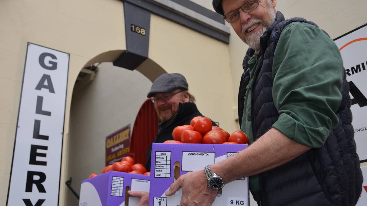 HEAVY LIFTING: Daryl Albertson and Greg Roberts help unpack a delivery of tomatoes which is destined to become a rich, creamy soup.