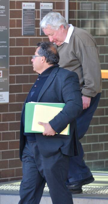 Berryman  leaving court with his lawyer Frank Falcomata.
