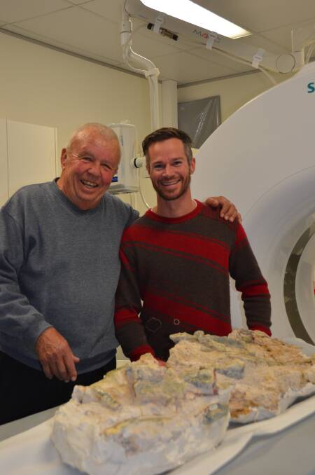 OLD FOSSIL: Bob Foster and Phil Bell take their millions of years old patient for its CAT scan. 