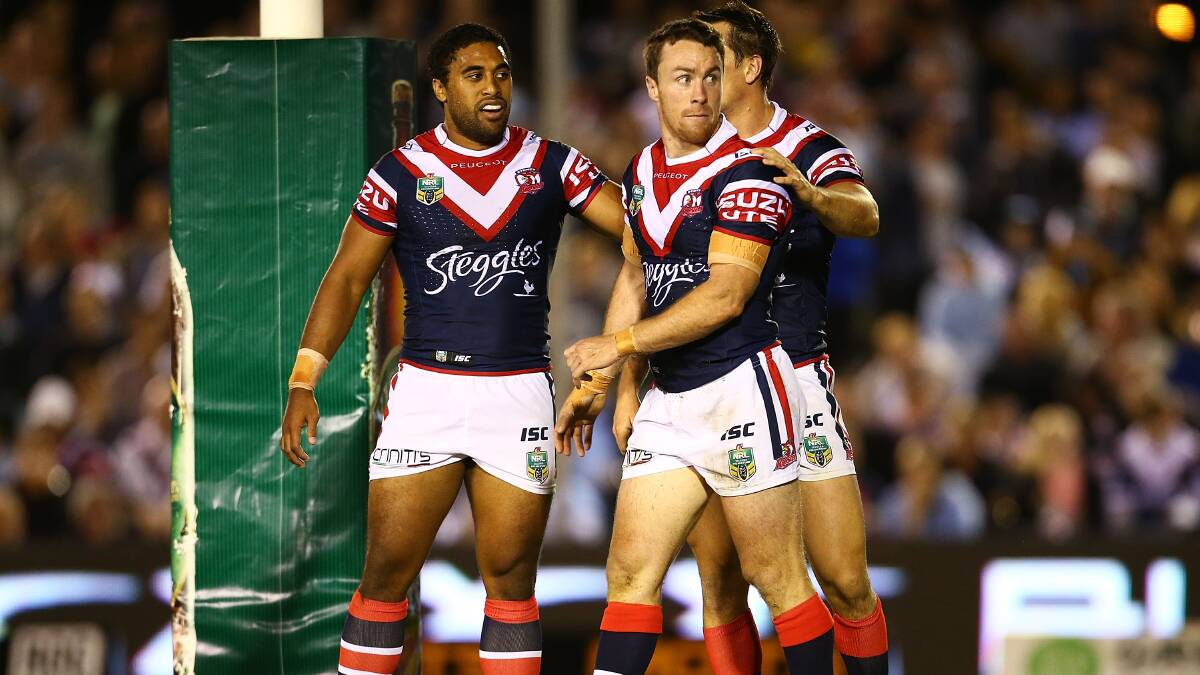 James Maloney of the Roosters is congratulated after scoring during the round seven NRL match between the Cronulla-Sutherland Sharks and the Sydney Roosters at Remondis Stadium on April 19, 2014 in Sydney, Australia. Photo: Mark Nolan/Getty Images.
