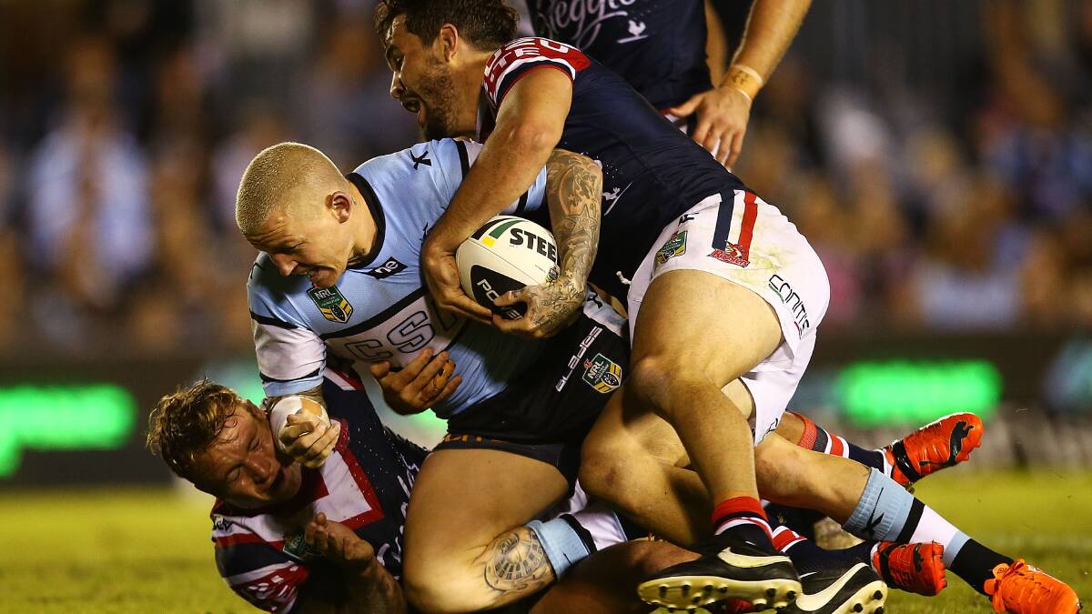  Todd Carney of the Sharks is tackled during the round seven NRL match between the Cronulla-Sutherland Sharks and the Sydney Roosters at Remondis Stadium on April 19, 2014 in Sydney, Australia. Photo: Mark Nolan/Getty Images.