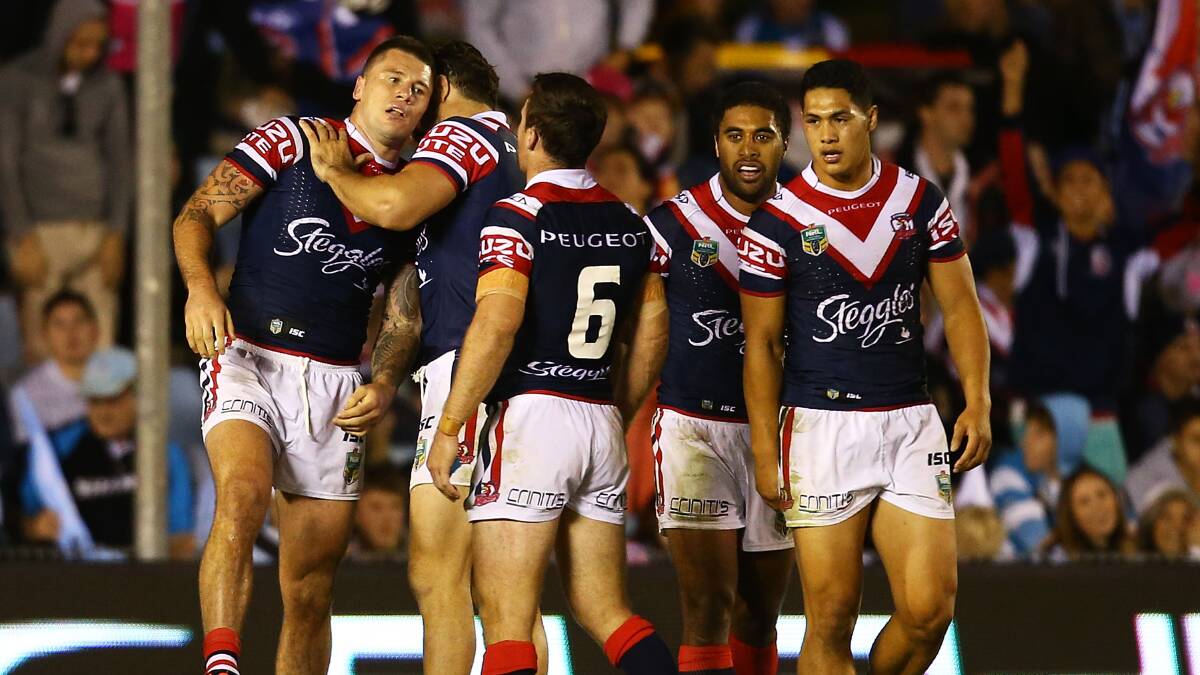 Shaun Kenny-Dowall of the Roosters is congratulaetd after a run away try during the round seven NRL match between the Cronulla-Sutherland Sharks and the Sydney Roosters at Remondis Stadium on April 19, 2014 in Sydney, Australia. Photo: Mark Nolan/Getty Images.
