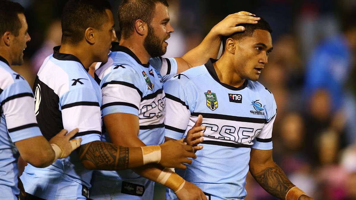 Ricky Leutele of the Sharks is congratulated by team mates after scoring during the round seven NRL match between the Cronulla-Sutherland Sharks and the Sydney Roosters at Remondis Stadium on April 19, 2014 in Sydney, Australia. Photo: Mark Nolan/Getty Images.