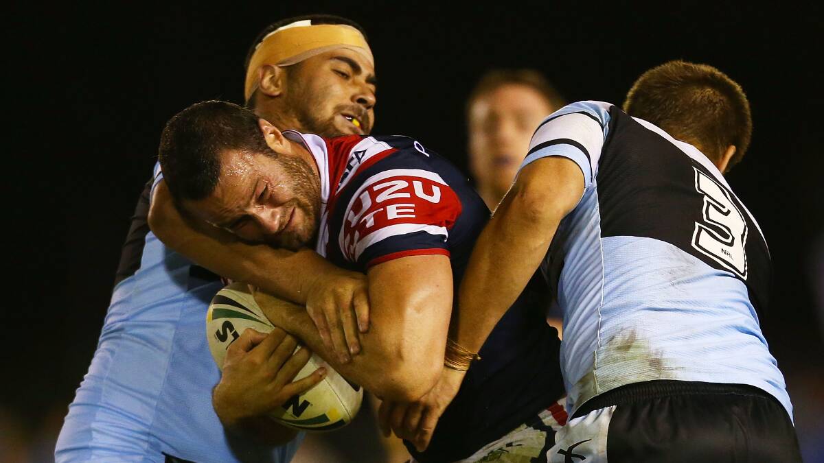 Boyd Cordner of the Roosters is tackled during the round seven NRL match between the Cronulla-Sutherland Sharks and the Sydney Roosters at Remondis Stadium on April 19, 2014 in Sydney, Australia. Photo: Mark Nolan/Getty Images.