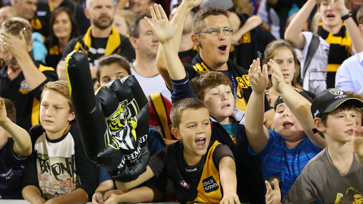 Tiger fans celebrate winning the round five AFL match between the Brisbane Lions and the Richmond Tigers at The Gabba on April 17, 2014 in Brisbane, Australia. Photo: Chris Hyde/Getty Images.