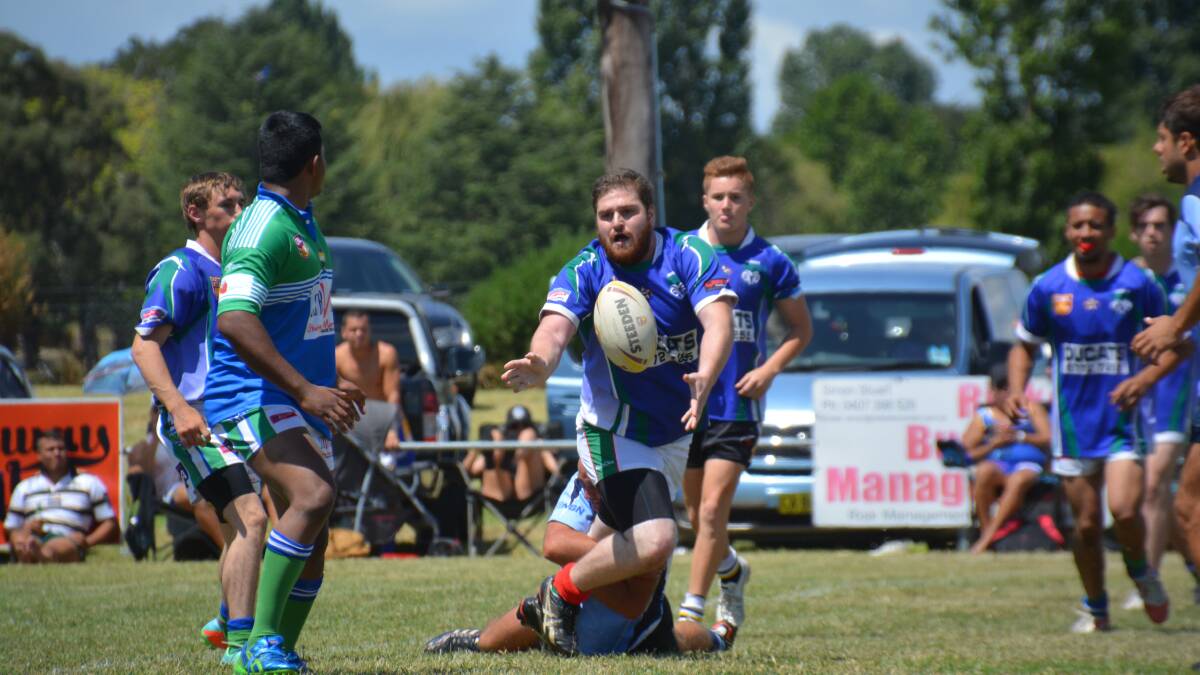 BATTLING ON: Brandon Grosse passes to Amith Kumar in the Armidale Ex-Services Nines tournament earlier this year. 