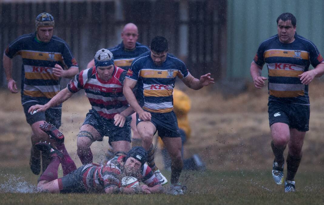 A BIT DAMP: Barbarians skipper Nick Dooner dives on a losse ball during his sides 35-10 win over competition leaders the Armidale Blues.