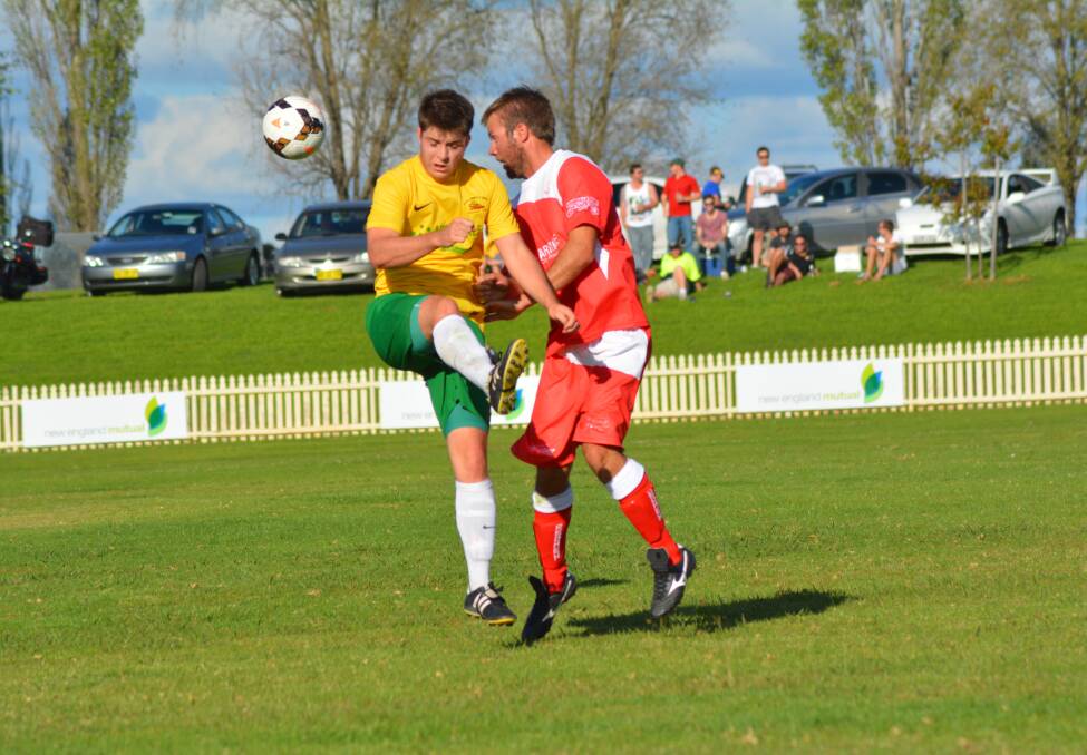 CONTEST: Michael Patterson from South Armidale and North Armidale’s Jason Boundy compete for the ball on Saturday.