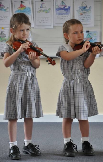 MINIATURE MAESTROS: Delilah Layton and Siena Hays love their music lessons.