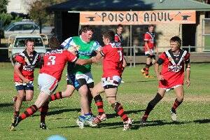 RAMBLED: Armidale Ram’ Matt Croft charges into the Warialda defence in the reserve grade encounter.