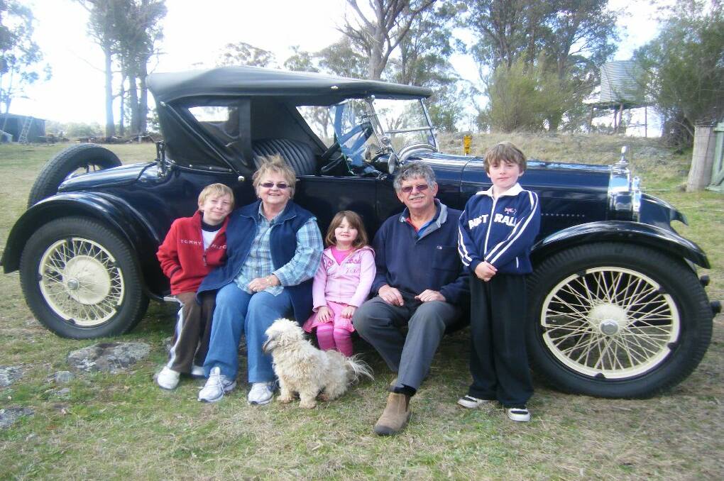 WHEEL DEAL: Lusy and Bob Willis and their grandchildren Nathan, Kianni and Luke Striecher in  Bob's 1924 Dodge truck that will appear in the film, The Great Gatsby. 
