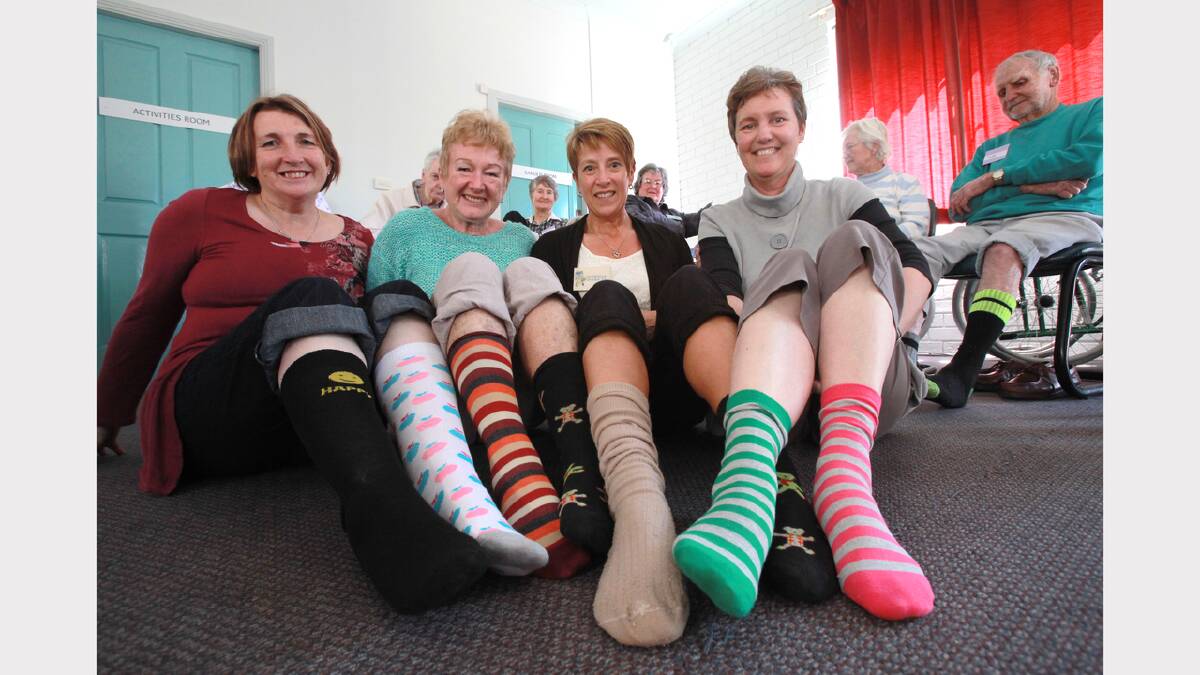 Council staff Sue Bannon, Jane Davies, Staphanie Watts and Hayley Ward and members of the Jacaranda Social Club get into the spirit of Odd Socks Day.