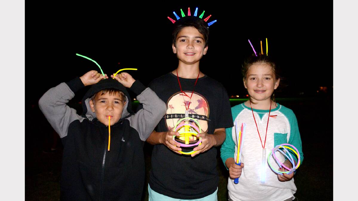 COLOURFUL COUSINS: Steven Briggs, 7, Dillon Hill, 12 and Lily Moor 9 added their own glow to the fireworks. Photo by GRANT ROBERTSON