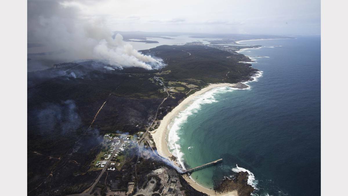 NEWCASTLE HERALD: Scenes from the fires at Catherine Hill Bay and Chain Valley Bay on Friday. Photo by James Brickwood 