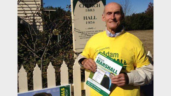 Arnold Goode, 81, hands out pamphlets for Nationals candidate Adam Marshall at Arding Uniting Church Hall.