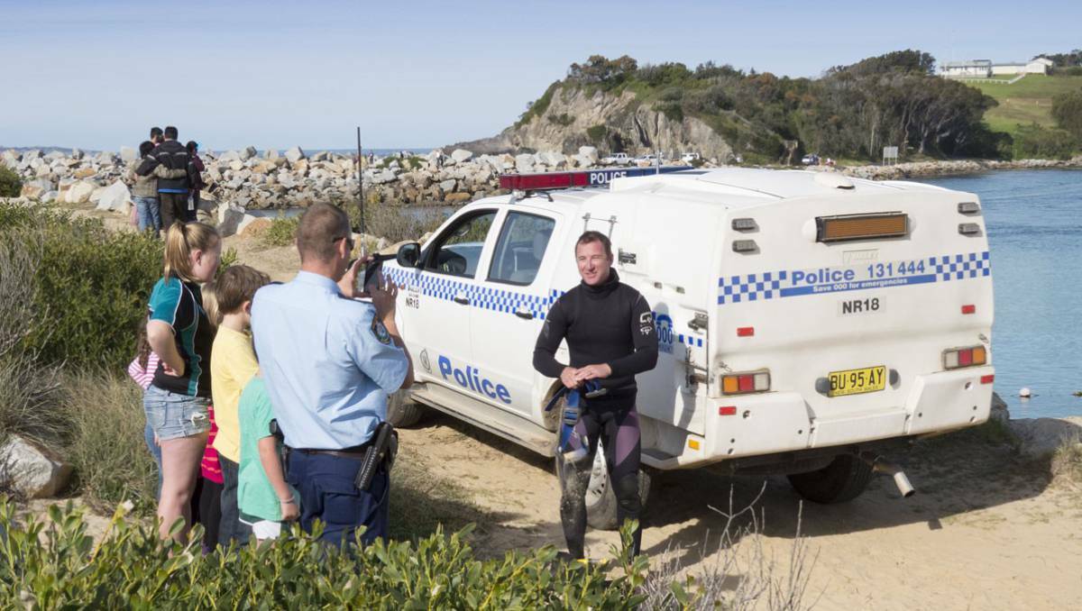 Senior Constable Graham Smeallie back on land in his dive gear after the shark rescue on Sunday. Photo: South Coast Register