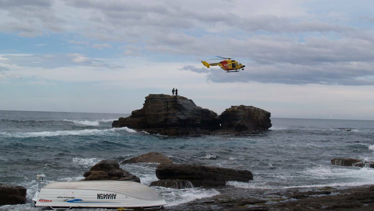 The Westpac Lifesaver helicopter winched an ACT man and woman to safety from rocks at South Durras on Monday. Photo: South Coast Register