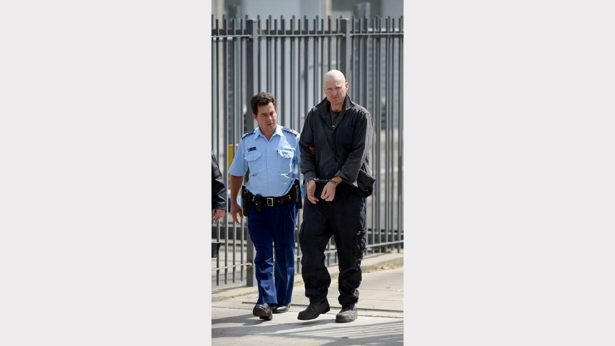 CHARGED: An officer escorts Matthew Cornish to Armidale Local Court yesterday. Photo: GRANT ROBERTSON