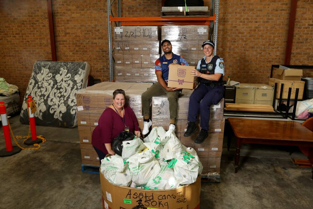 HIGH DEMAND: Survivors R Us founder, Maria Martin, with Lake Macquarie Aboriginal community liaison officer Ray Fuller and Senior Constable Elke Watt. The group has pushed out 3000 hampers. Picture: Jonathan Carroll.