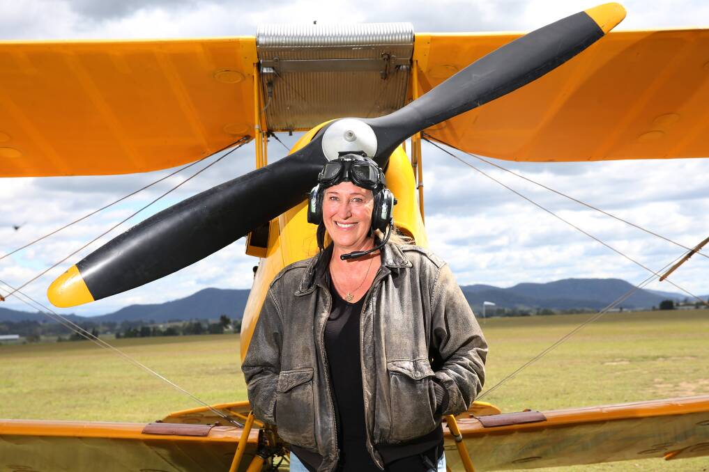 PASSIONATE: Veteran pilot Charlotte Zeederberg, with her prized deHavilland Tiger Moth, known as Tweety Bird, that she was forced to land on Blacksmiths Beach in 2019 following engine failure. Pictures: Peter Lorimer.