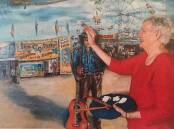 A LIFE WELL LIVED: Norma Brophy does some touch-ups to her Slim Dusty portrait painted on an old circus canvas.