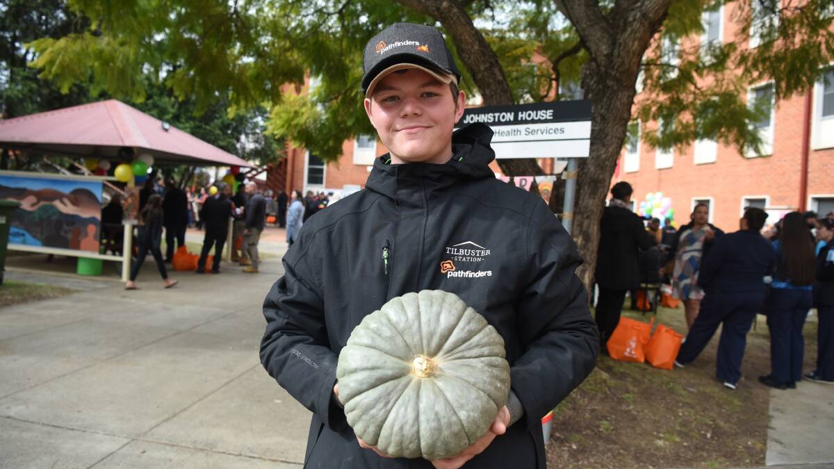 Armidale local Tenshion Booby, 16, in Tamworth, holds one of the many pumpkins grown by children and teenagers at Pathfinders' farm Tilbuster Station. Picture supplied