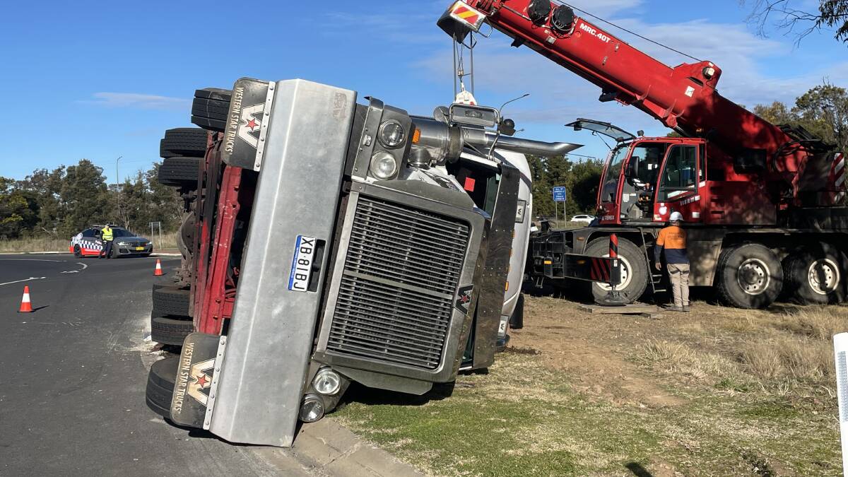 The Western Star prime mover on its side with a crane in the background. Picture: Rachel Gray.