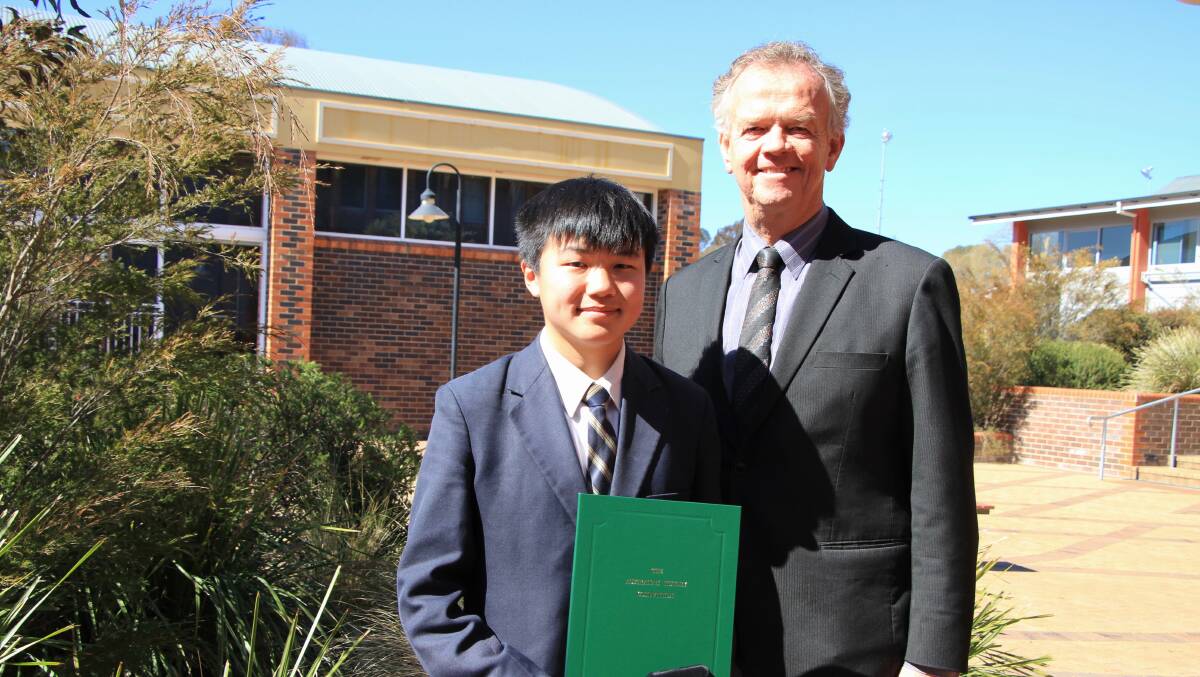 TOP SPOT: TAS Headmaster Murray Guest congratulates Thomas Wu on being named Year 10 national champion in the Australian History Competition.