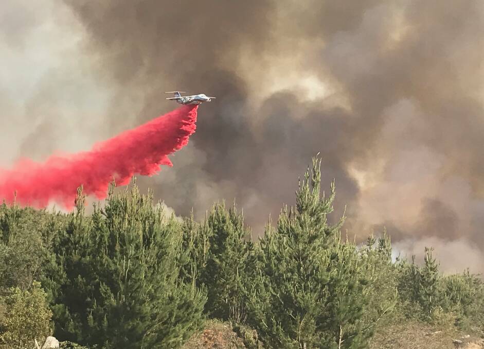 Air attack: The RFS air tanker drops retardant at the height of the fire, when it was out of control. Photo: Forestry Corporation NSW.