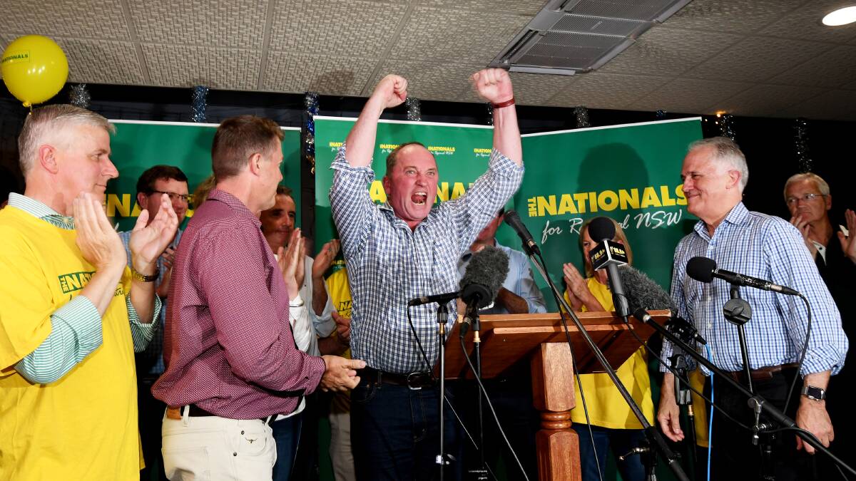 BIG WIN: Barnaby Joyce celebrates the win, flanked by his supporters and Prime Minister Malcolm Turnbull. Photo: Gareth Gardner