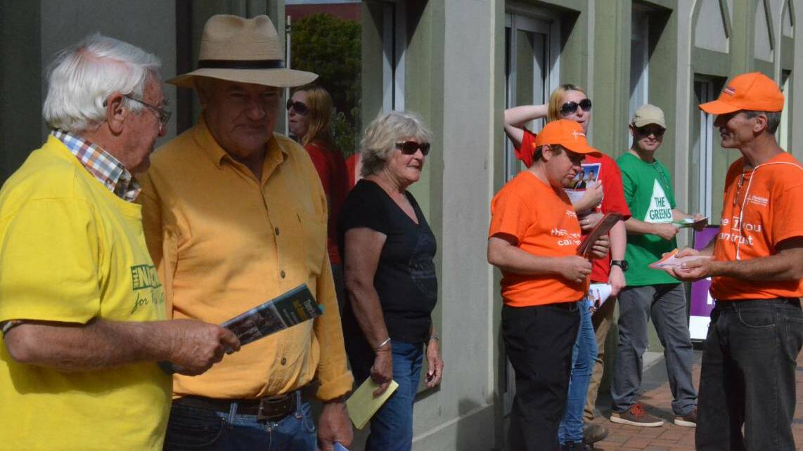 Early votes: Party volunteers hand out at pre-polling in Armidale. Photo: Rachel Baxter
