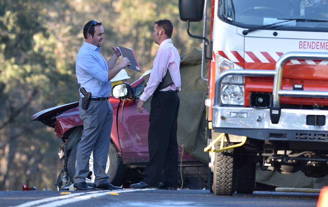 HIGHWAY HORROR: New England detectives at the scene of the head-on collision south of Uralla which killed two men, including a UNE student. Photo: Gareth Gardner