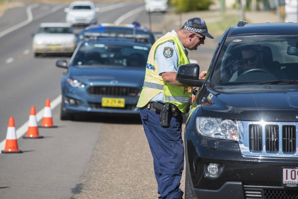 Cop stop: A driver is breath tested on Armidale Rd in Tamworth during Operation Tortoise on the Easter long weekend. Photo: Peter Hardin 140417PHD014
