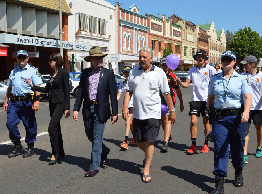 Backing the cause: New England police join community members in a march against domestic violence in Inverell, last year, for White Ribbon Day. 