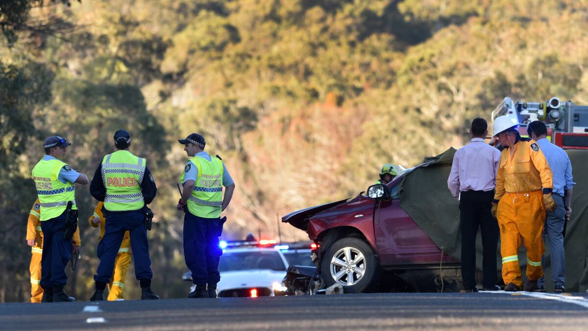 HIGHWAY HORROR: Police and New England detectives at the scene of the head-on collision south of Uralla which killed two men, including a UNE student. Photo: Gareth Gardner